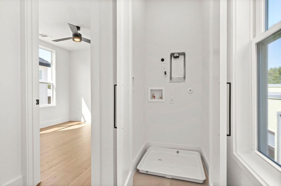 Laundry area featuring hookup for a washing machine, light wood-style floors, and ceiling fan