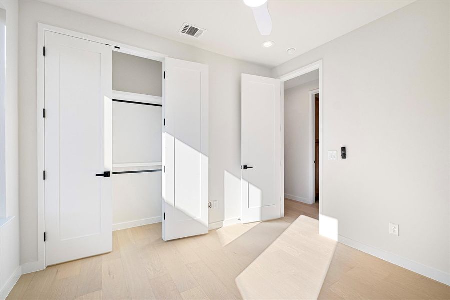 Unfurnished bedroom featuring light wood-type flooring, a closet, ceiling fan, and recessed lighting