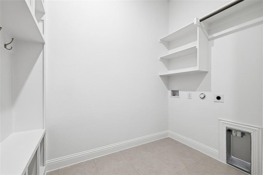 Washroom featuring hookup for a gas dryer, hookup for an electric dryer, hookup for a washing machine, and light tile patterned floors Washroom featuring hookup for a gas dryer, hookup for an electric dryer, hookup for a washing machine, and light tile patterned floors