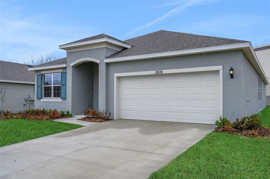 Front exterior of a new home in Seaport Village, Tavares, FL, highlighting curb appeal (Image 17). Front exterior of a new home in Seaport Village, Tavares, FL, highlighting curb appeal (Image 17).