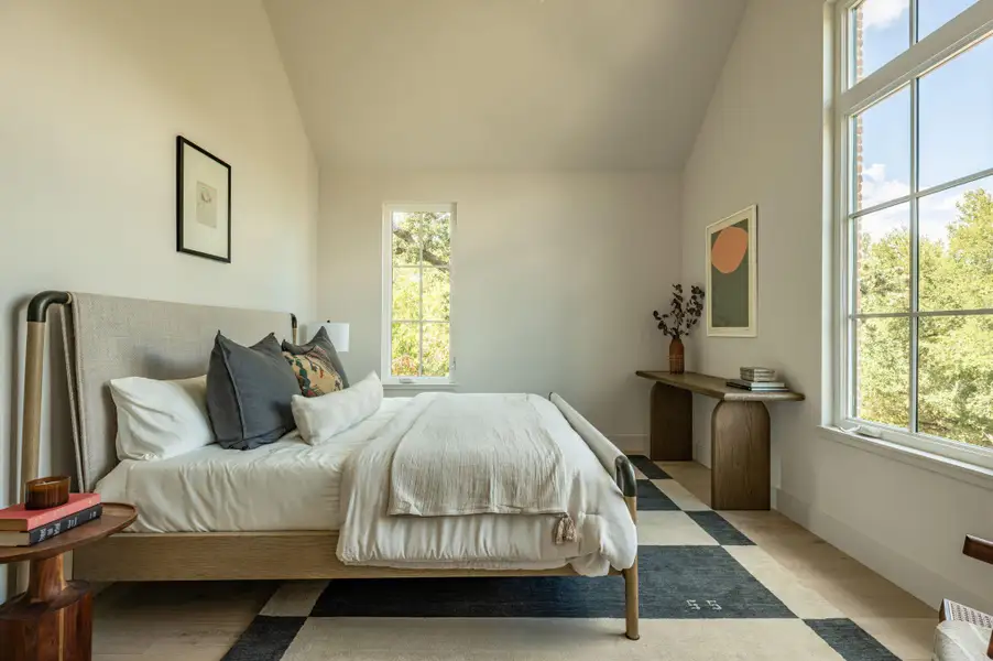 Vaulted ceilings and hardwood floors frame this serene bedroom retreat with large multi-pane windows. Vaulted ceilings and hardwood floors frame this serene bedroom retreat with large multi-pane windows.
