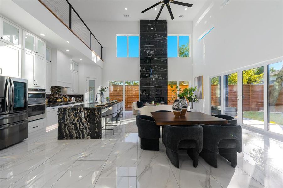 Open concept living, dining and kitchen with 20 foot ceilings. Open concept living, dining and kitchen with 20 foot ceilings.