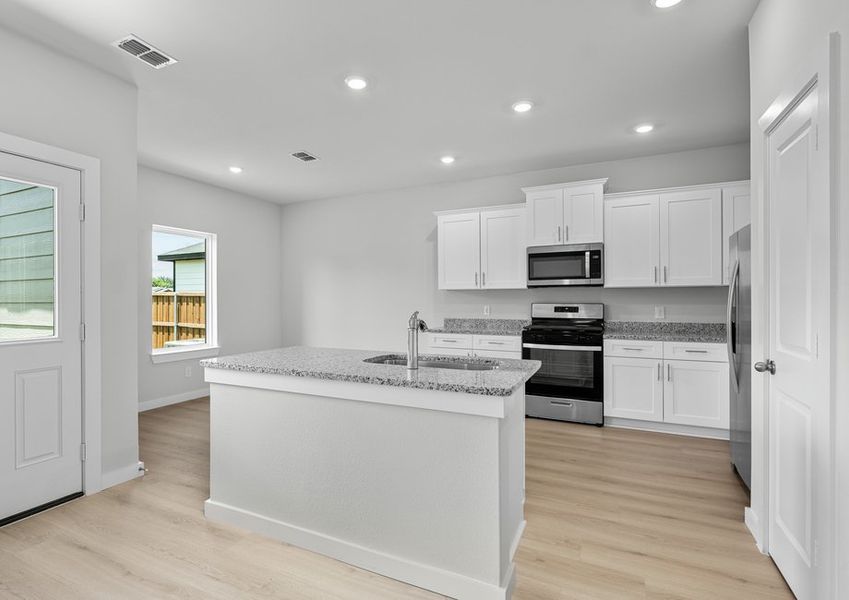 Beautiful kitchen with white cabinetry, granite counters, an island and stainless steel appliances. Beautiful kitchen with white cabinetry, granite counters, an island and stainless steel appliances.