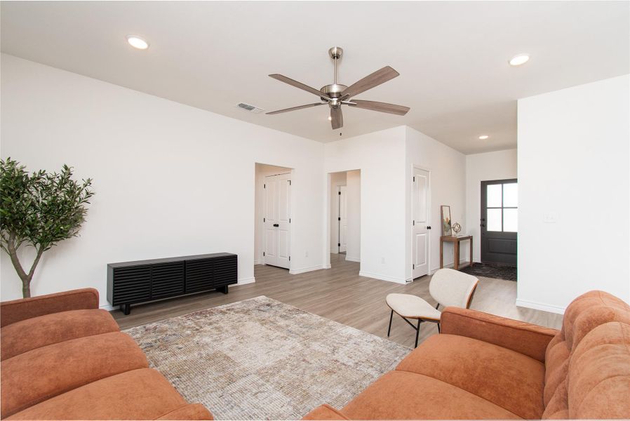 Living area featuring recessed lighting, light wood finished floors, and ceiling fan