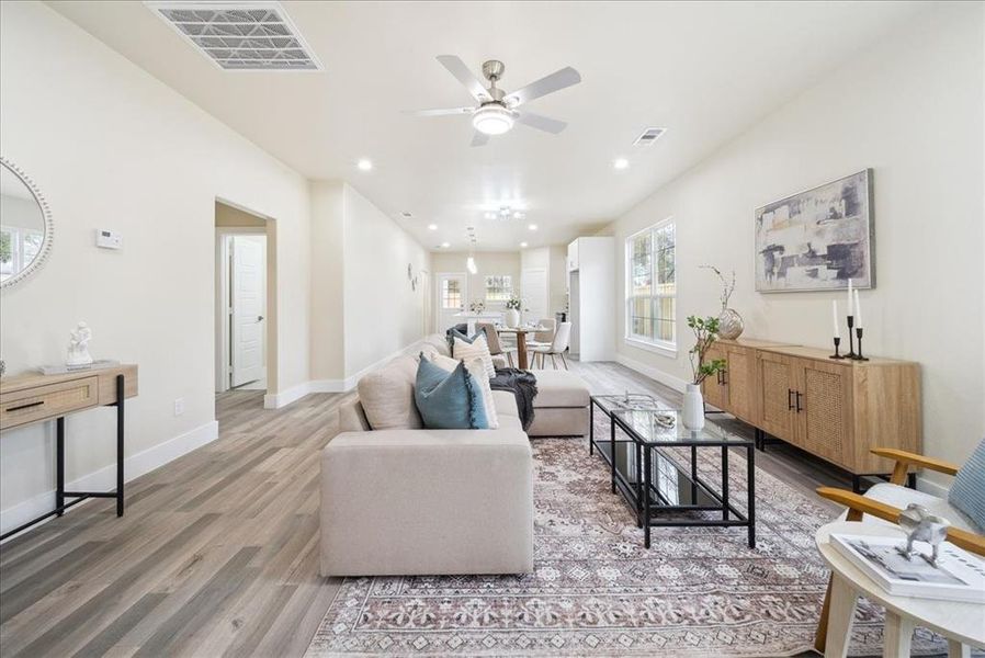 Living room featuring ceiling fan and wood-type flooring