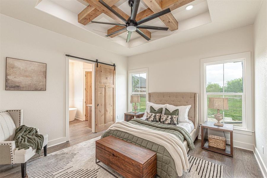 Bedroom with a barn door, coffered ceiling, light wood finished floors, recessed lighting, and a ceiling fan