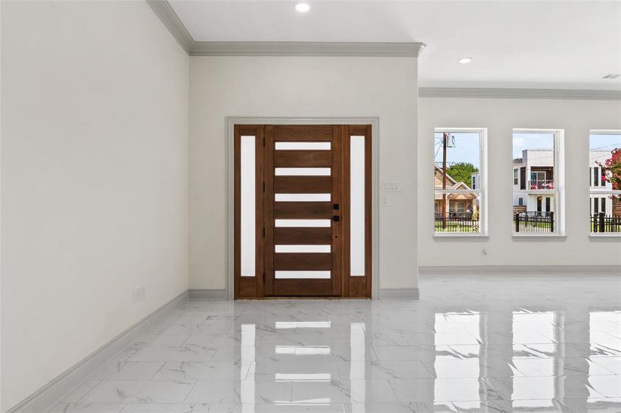 Foyer featuring crown molding, finish floors, and recessed lighting Foyer featuring crown molding, finish floors, and recessed lighting