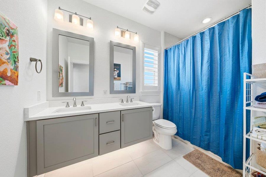 Clean lines and a spacious dual vanity define this modern, light-filled bathroom. Clean lines and a spacious dual vanity define this modern, light-filled bathroom.