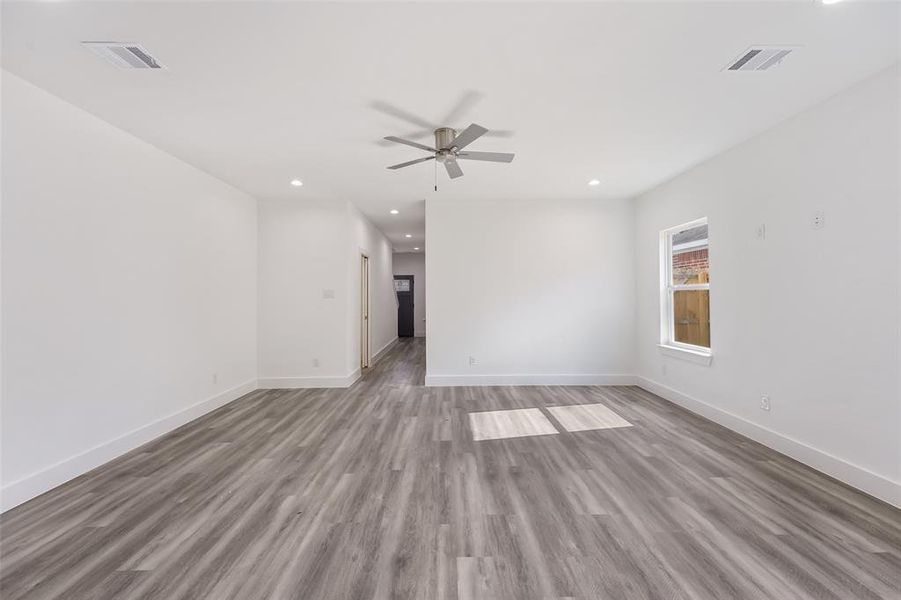 Empty room with wood finished floors, recessed lighting, and ceiling fan