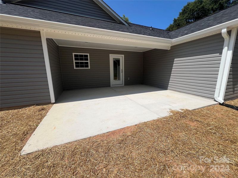 Rear View - Covered Porch and Patio Area