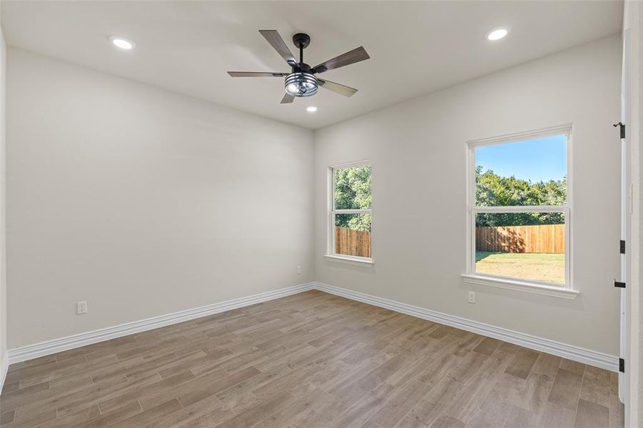 Spare room with light hardwood / wood-style flooring and ceiling fan