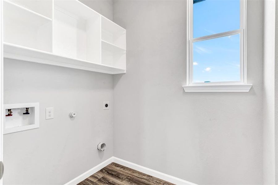 Washroom with hookup for a washing machine, electric dryer hookup, and hardwood / wood-style floors