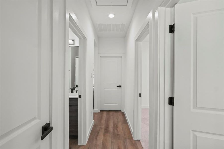 Hallway featuring wood-type flooring and sink