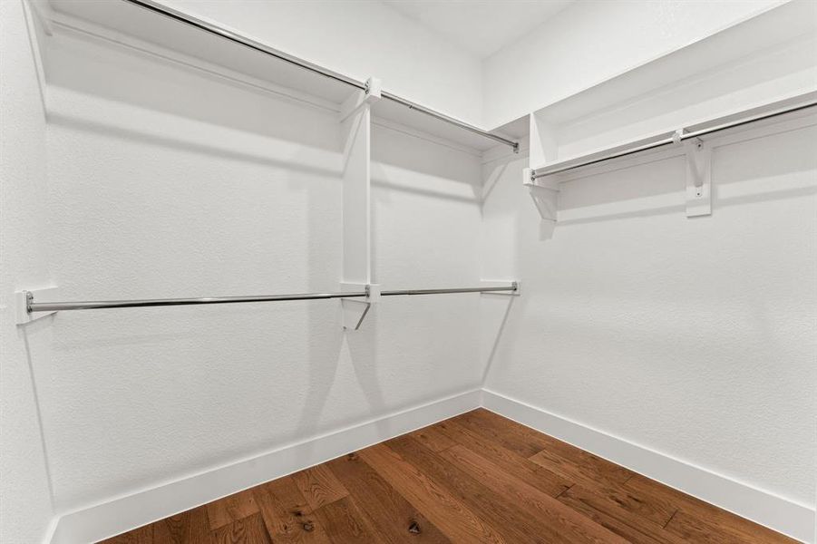 Spacious closet featuring hardwood / wood-style flooring