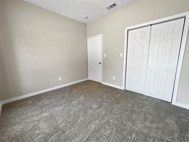 Unfurnished bedroom featuring carpet and a closet