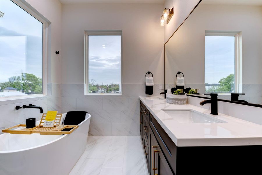 Gorgeous black cabinets with brass silverware and abundant natural lighting Gorgeous black cabinets with brass silverware and abundant natural lighting