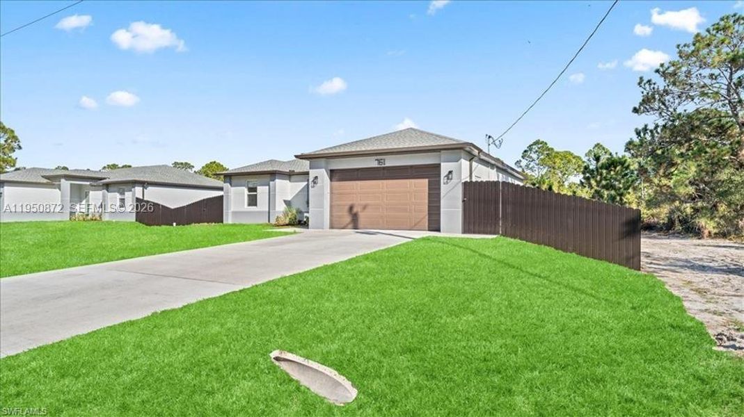Front exterior of a new home in , Lehigh Acres, FL, highlighting curb appeal (Image 21).