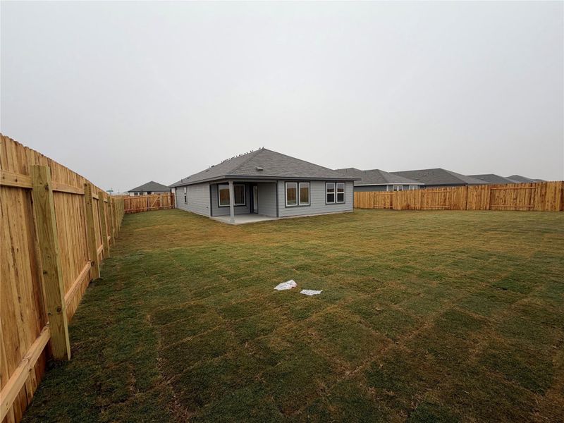 Rear view of house featuring a patio and a fenced backyard Rear view of house featuring a patio and a fenced backyard