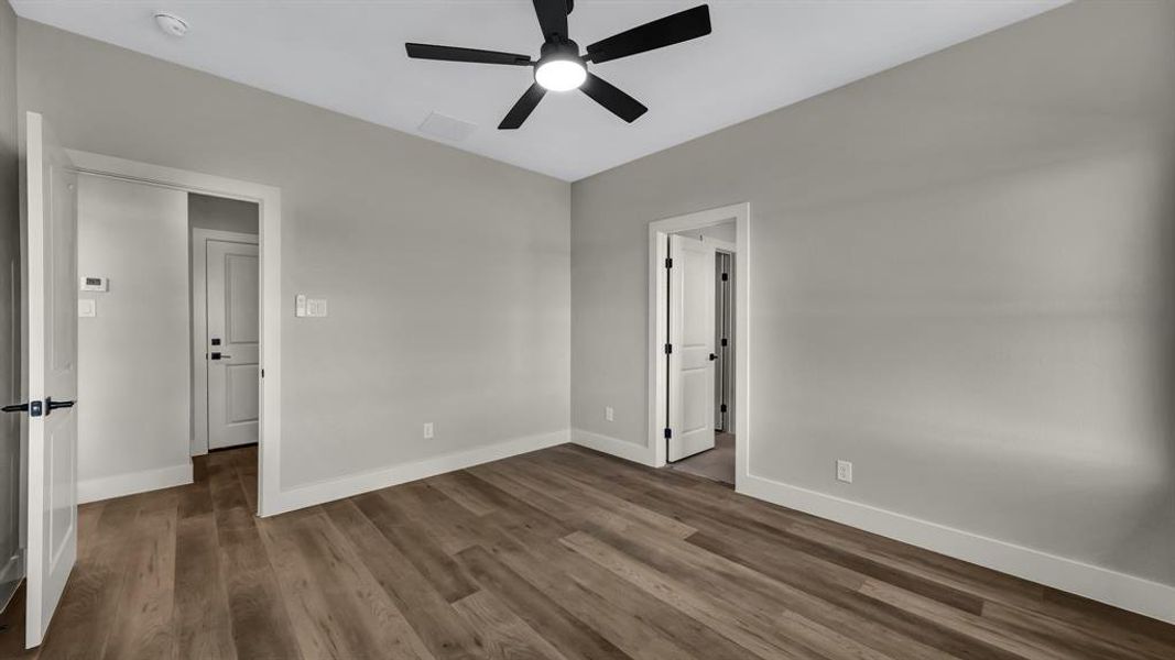 Unfurnished room featuring dark wood finished floors and ceiling fan