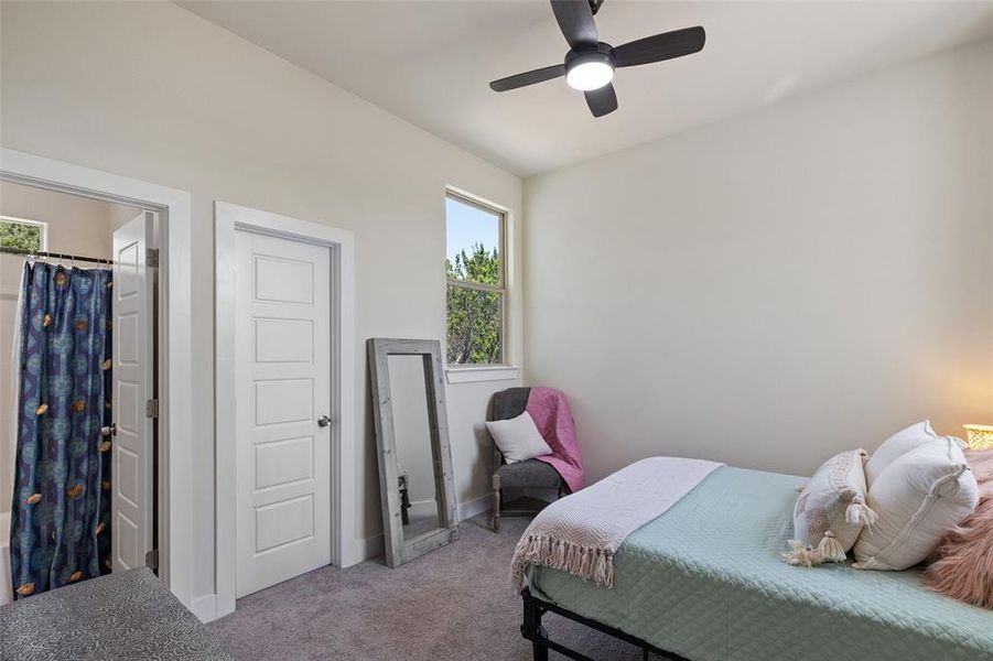 Upstairs bedroom featuring carpet floors, ceiling fan, and a closet