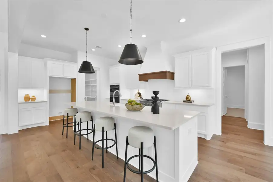Wood floors add warmth and texture in the kitchen and pairs perfectly with black accents. Wood floors add warmth and texture in the kitchen and pairs perfectly with black accents.