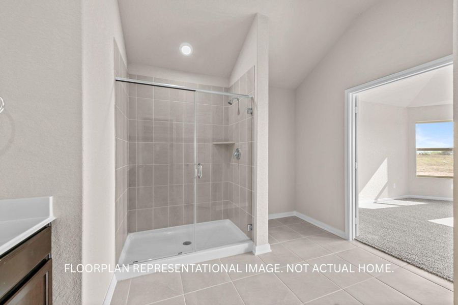 A well-appointed bathroom offers a glass-enclosed shower and practical vanity space.