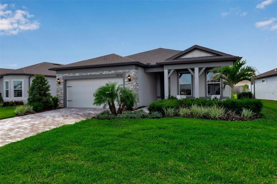 Front exterior of a new home in Del Webb BayView, Parrish, FL, highlighting curb appeal (Image 21). Front exterior of a new home in Del Webb BayView, Parrish, FL, highlighting curb appeal (Image 21).