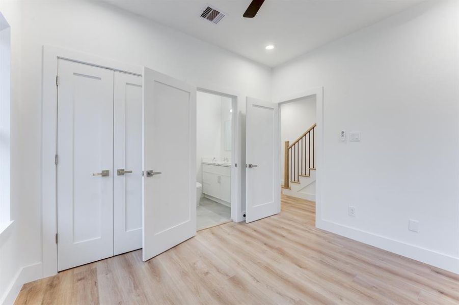 Beautiful room with ensuite bathroom, ceiling fan, recessed lighting, and luxury vinyl plank throughout.