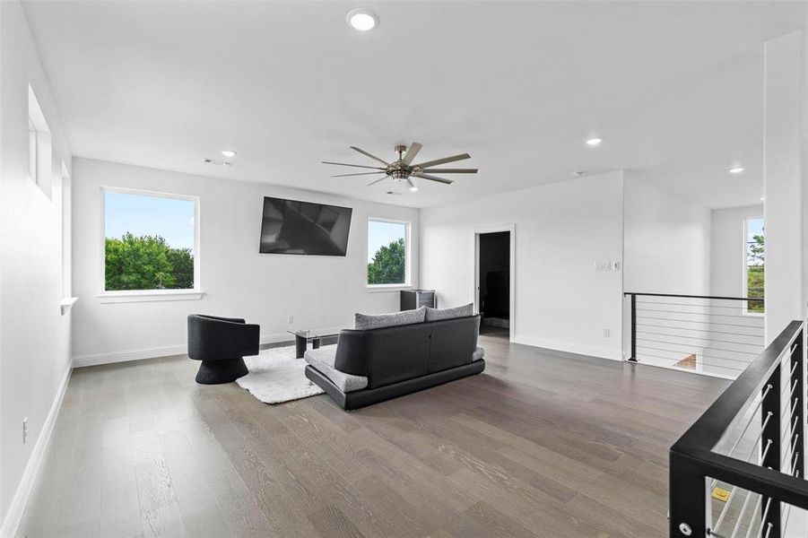 Living room featuring ceiling fan and hardwood / wood-style flooring