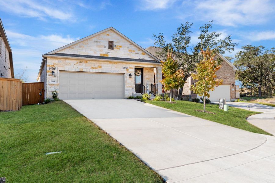 View of front of property with driveway, a garage, and stone siding View of front of property with driveway, a garage, and stone siding