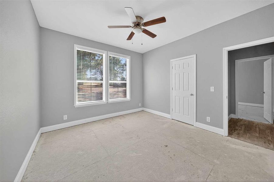 Unfurnished bedroom with a ceiling fan and baseboards
