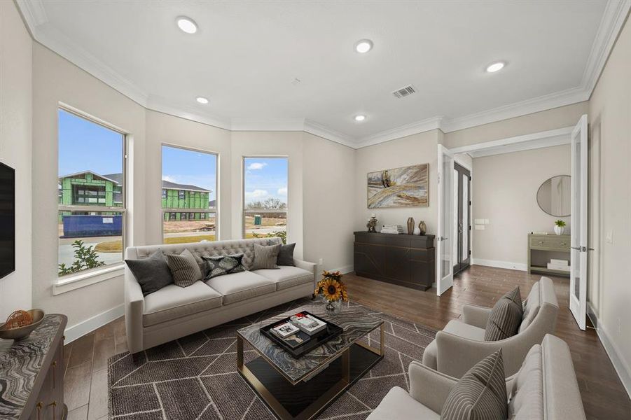 Virtually Staged: Fabulous sitting room, ideal for entertaining guests. It has new tile floors, crown molding details, recessed lighting, and large windows.