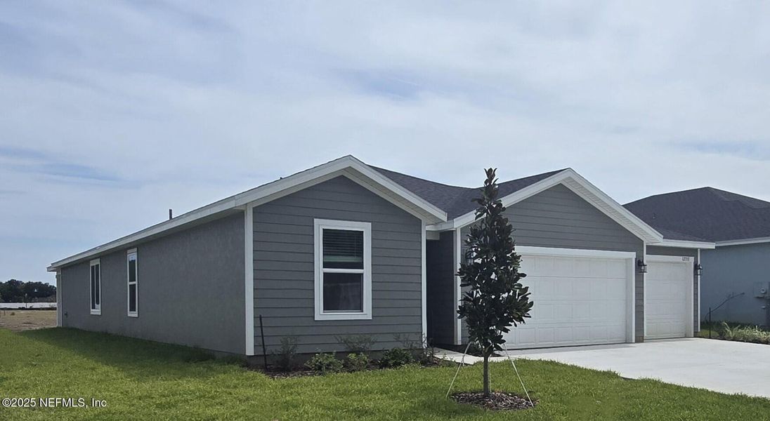 Front exterior of a new home in Azalea Creek, Jacksonville, FL, highlighting curb appeal (Image 22).