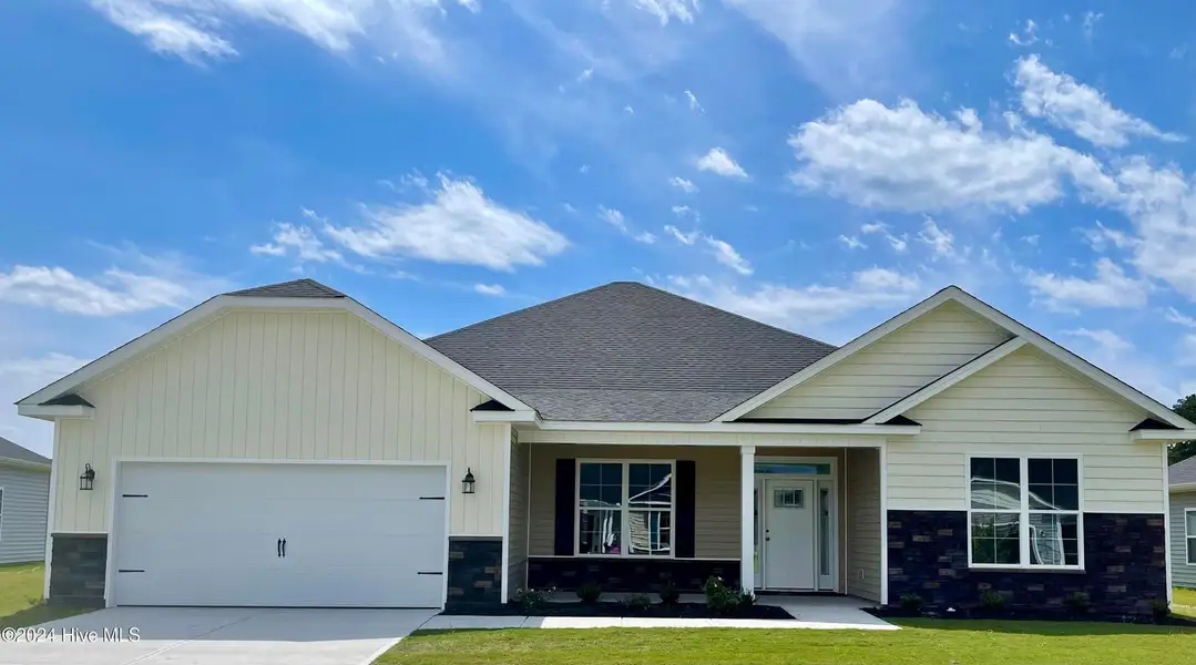 Front exterior of a new home in Summer Place, Grimesland, NC, highlighting curb appeal (Image 1). Front exterior of a new home in Summer Place, Grimesland, NC, highlighting curb appeal (Image 1).