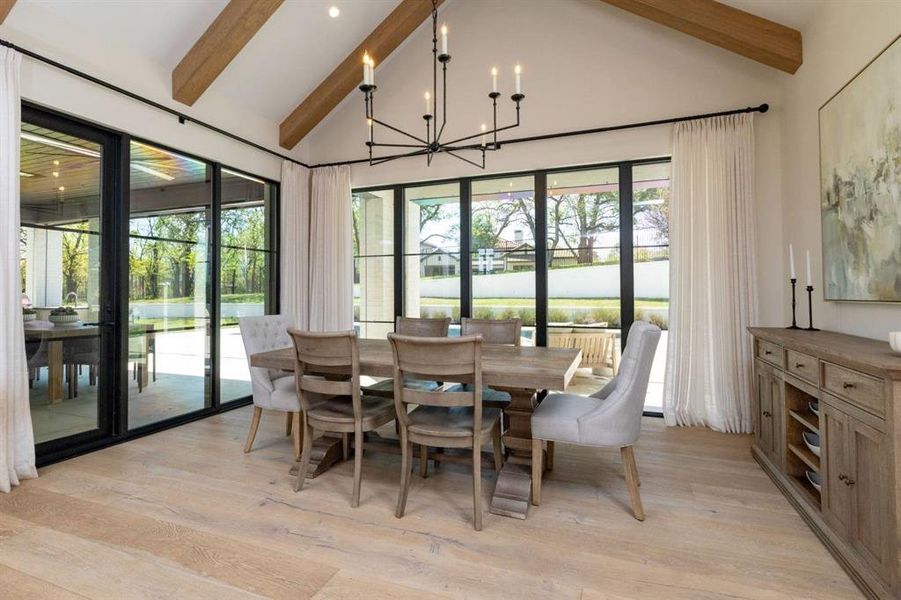 The dining room with it's beautiful beams overlooks the pool and backyard living space.