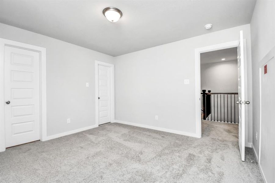 Generously sized secondary bedrooms featuring spacious closets, soft and inviting carpeting underfoot, large windows allowing plenty of natural light, and the added touch of privacy blinds for your personal retreat.