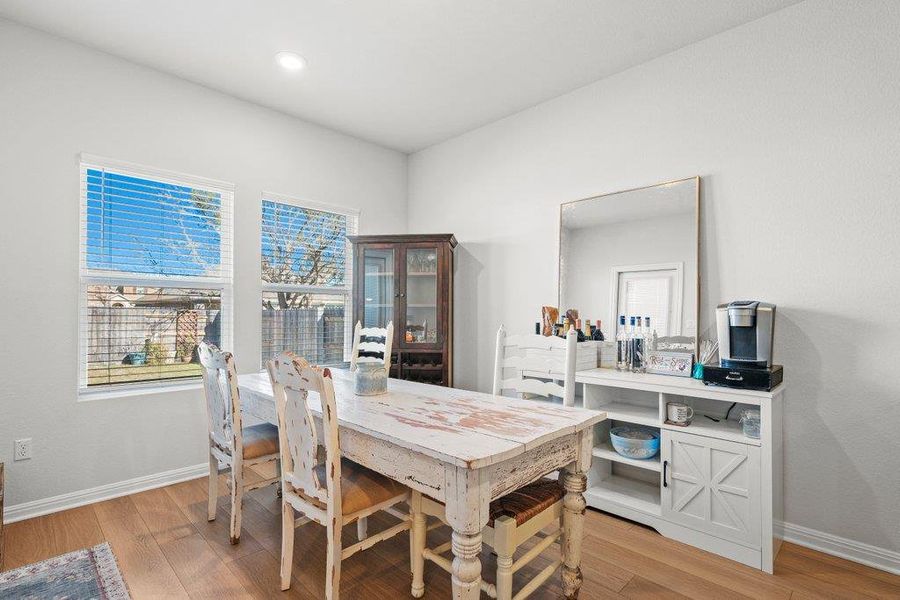 Dining room featuring light wood-type flooring and recessed lighting