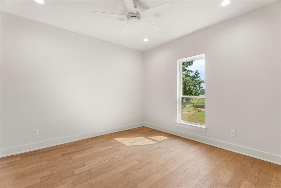 Unfurnished room with light wood finished floors, recessed lighting, and a ceiling fan