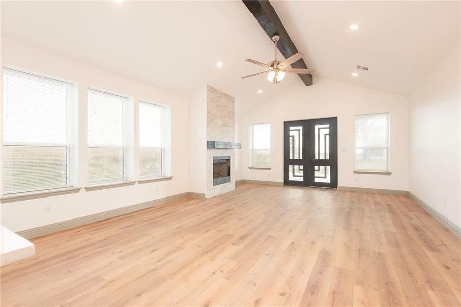 Unfurnished living room featuring light wood finished floors, a large fireplace, and recessed lighting