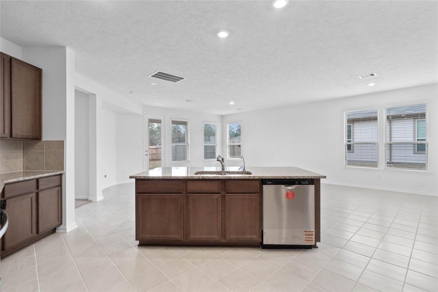 A commanding view of the open-concept design which seamlessly connects the living, dining, and kitchen areas—perfect for both everyday living and entertaining!