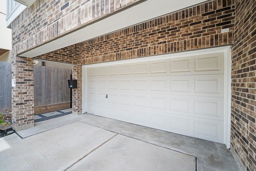 The deep porte-cochère at the front of the home shelters the garage entry and is pre-wired for exterior security cameras at both front and back — well-built from the curb in. The deep porte-cochère at the front of the home shelters the garage entry and is pre-wired for exterior security cameras at both front and back — well-built from the curb in.