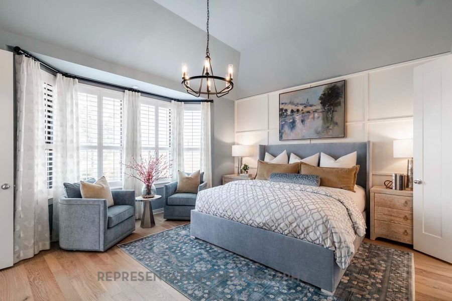 Bedroom with a chandelier and wood finished floors Bedroom with a chandelier and wood finished floors