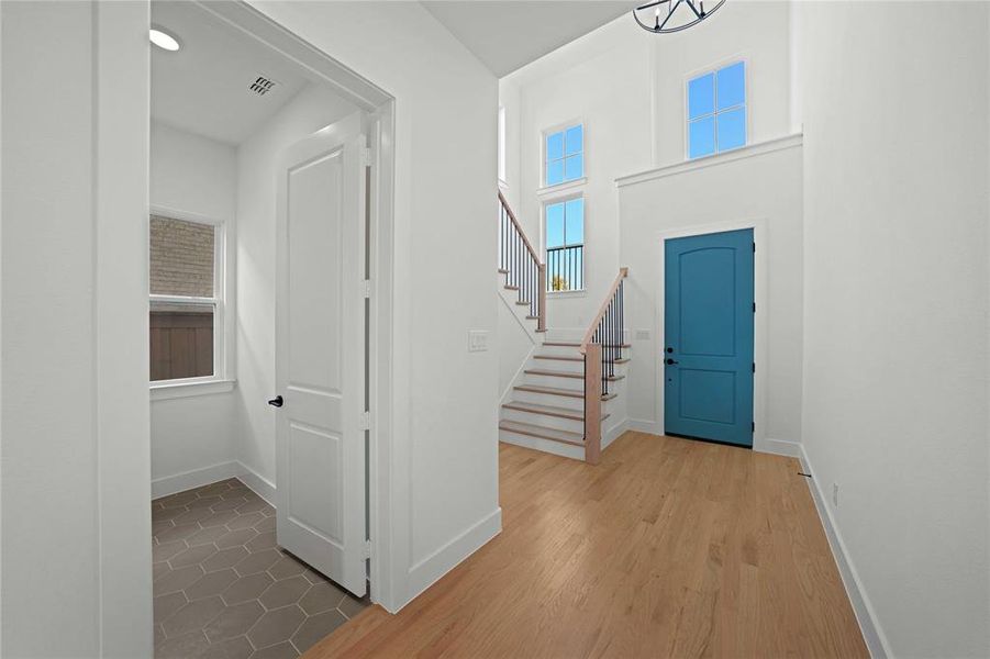 Entryway featuring wood finished floors and stairway Entryway featuring wood finished floors and stairway