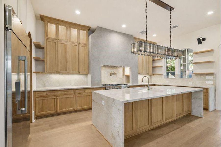 Chefs kitchen with oversized island, luxury appliances, high end finishes, and prep pantry   *this photo has been virtually rendered based on a previous home constructed by the builder. 1519 Candlelight may have different selections at builders sole discretion. These photos are not meant to be an exact representation of 1519 Candlelight.