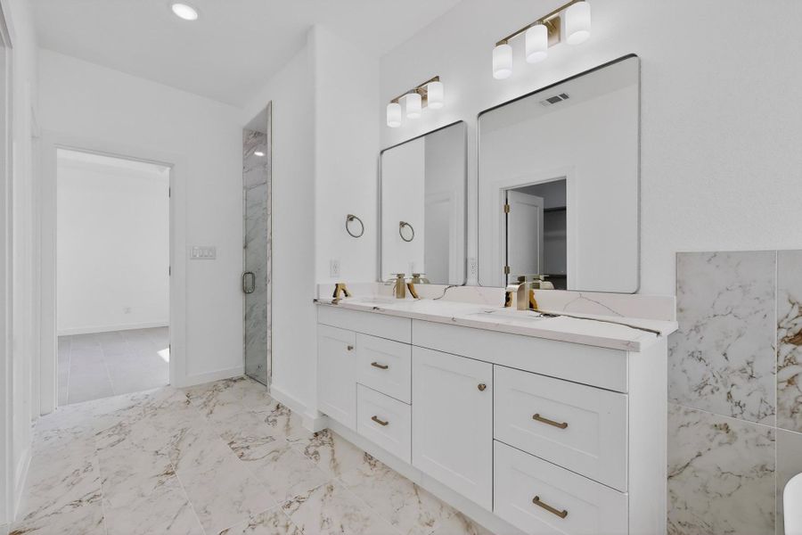 Bathroom featuring double vanity, and recessed lighting