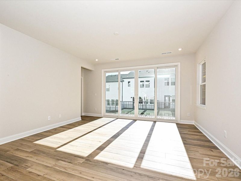 Great Room Seeped in Natural Light Through Sliding Doors to Outdoor Living.