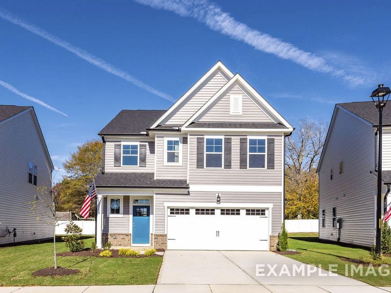 Front exterior of a new home in Woodland Crossing, Zebulon, NC, highlighting curb appeal (Image 2).