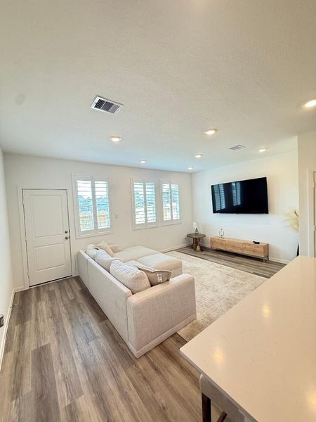 family room with wall of windows. Look at the shutters