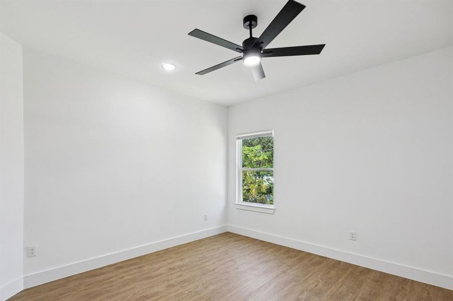 Empty room with light wood-style flooring, recessed lighting, and a ceiling fan