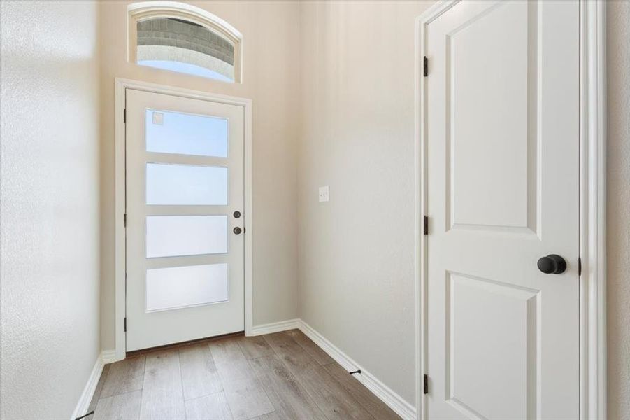 Foyer entrance with light wood-style floors and baseboards Foyer entrance with light wood-style floors and baseboards